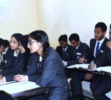 A diverse group of male and female students in uniform sitting at wooden desks attentively focusing on a lecture.
