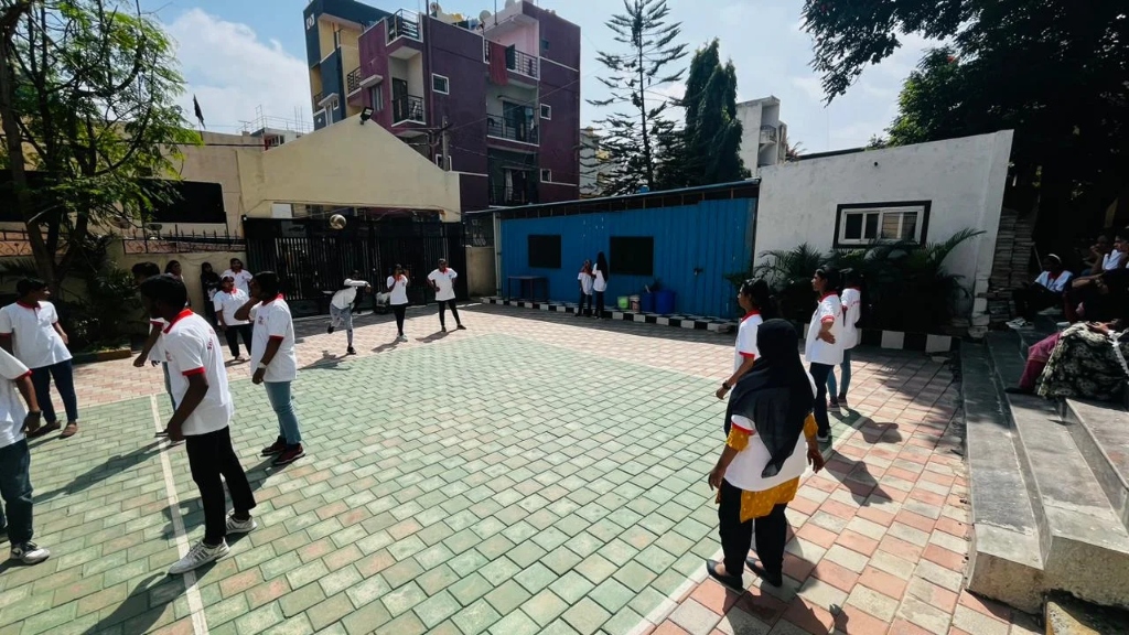 Students getting ready to play a game on the sports court.